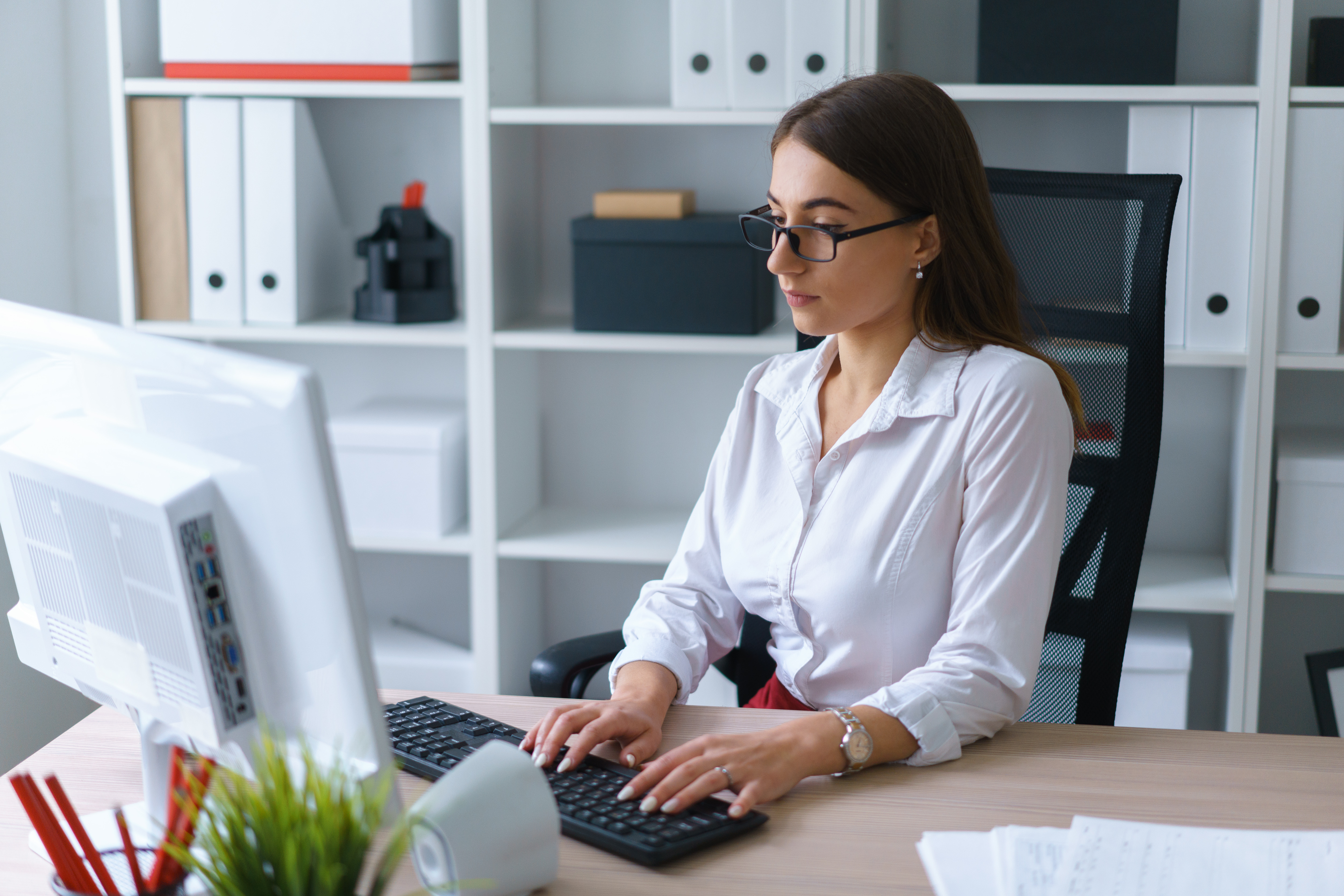 Young businesswoman work on keyboard computer sit at table at office - MoCRA Compliance Services Lab